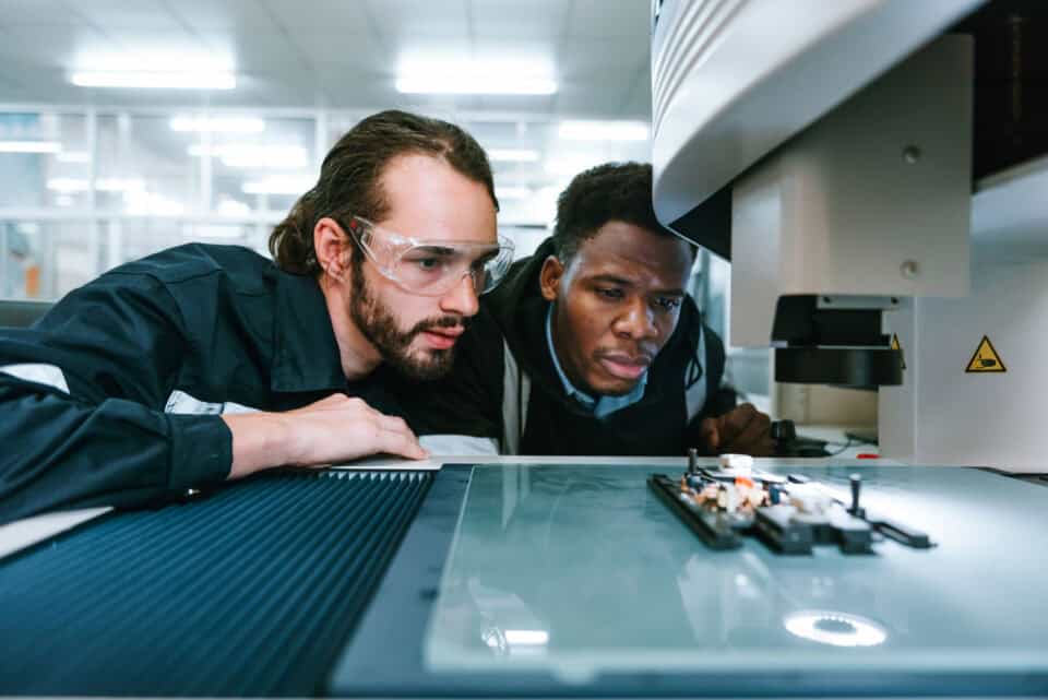 Innovative engineers working on high-tech electronics in a modern laboratory setting.